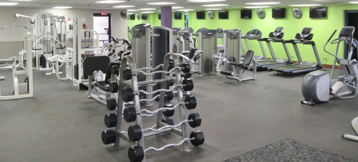 A well-equipped fitness center featuring weightlifting equipment, treadmills, and elliptical machines, all set in a bright and motivational environment. The space is conducive for both solo workouts and group exercise sessions, offering a glimpse of the resort's commitment to healthy, active living.